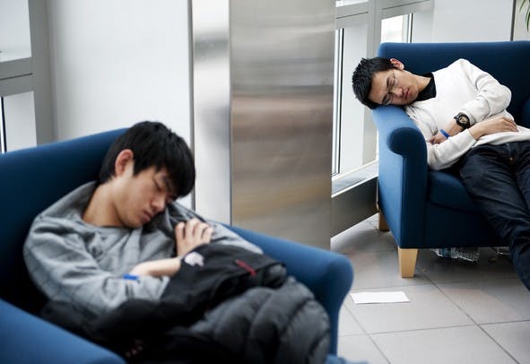 Two developers rest during a hackathon. Photo courtesy of Ann Arbor.