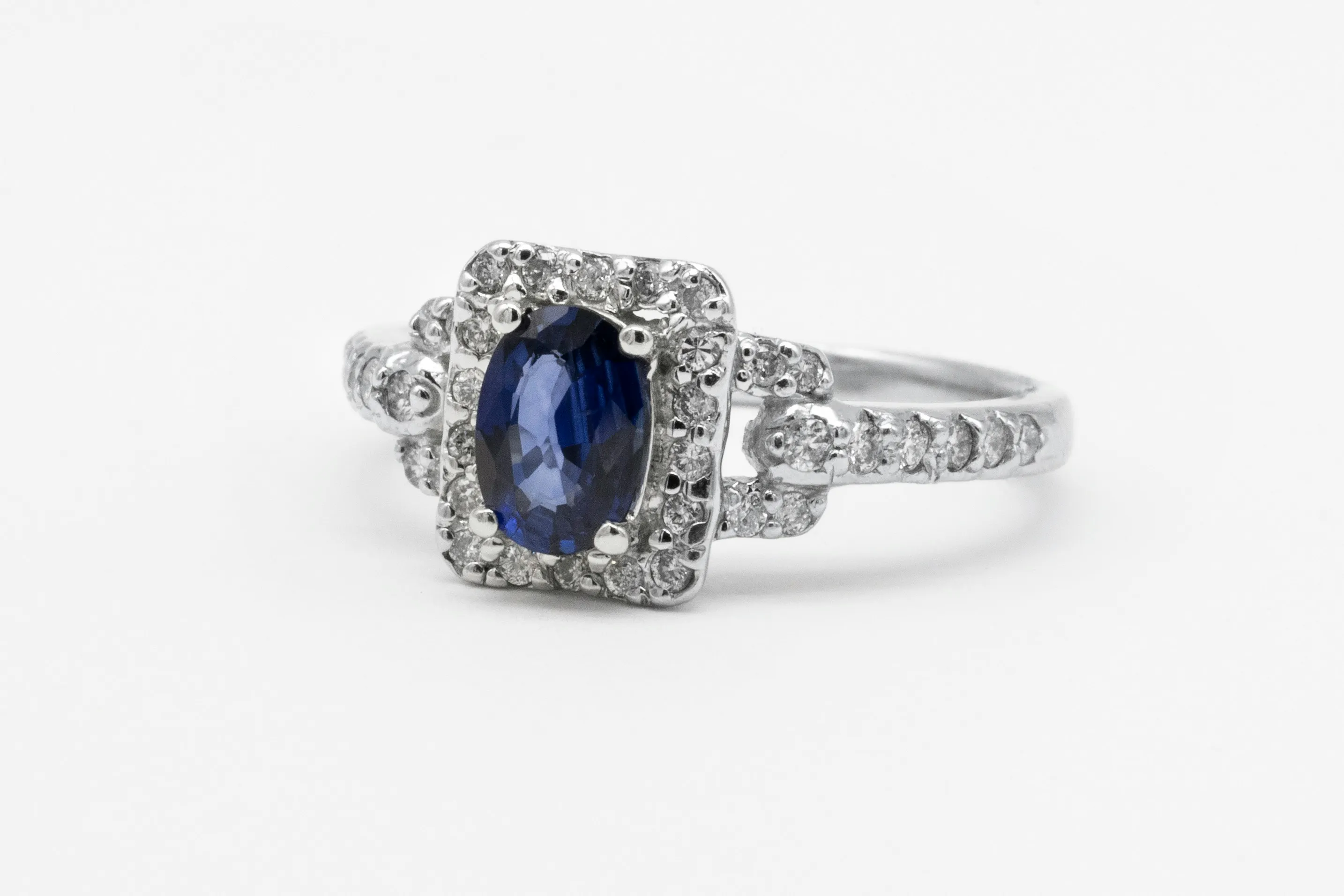Blue sapphire engagement ring with a diamond halo
