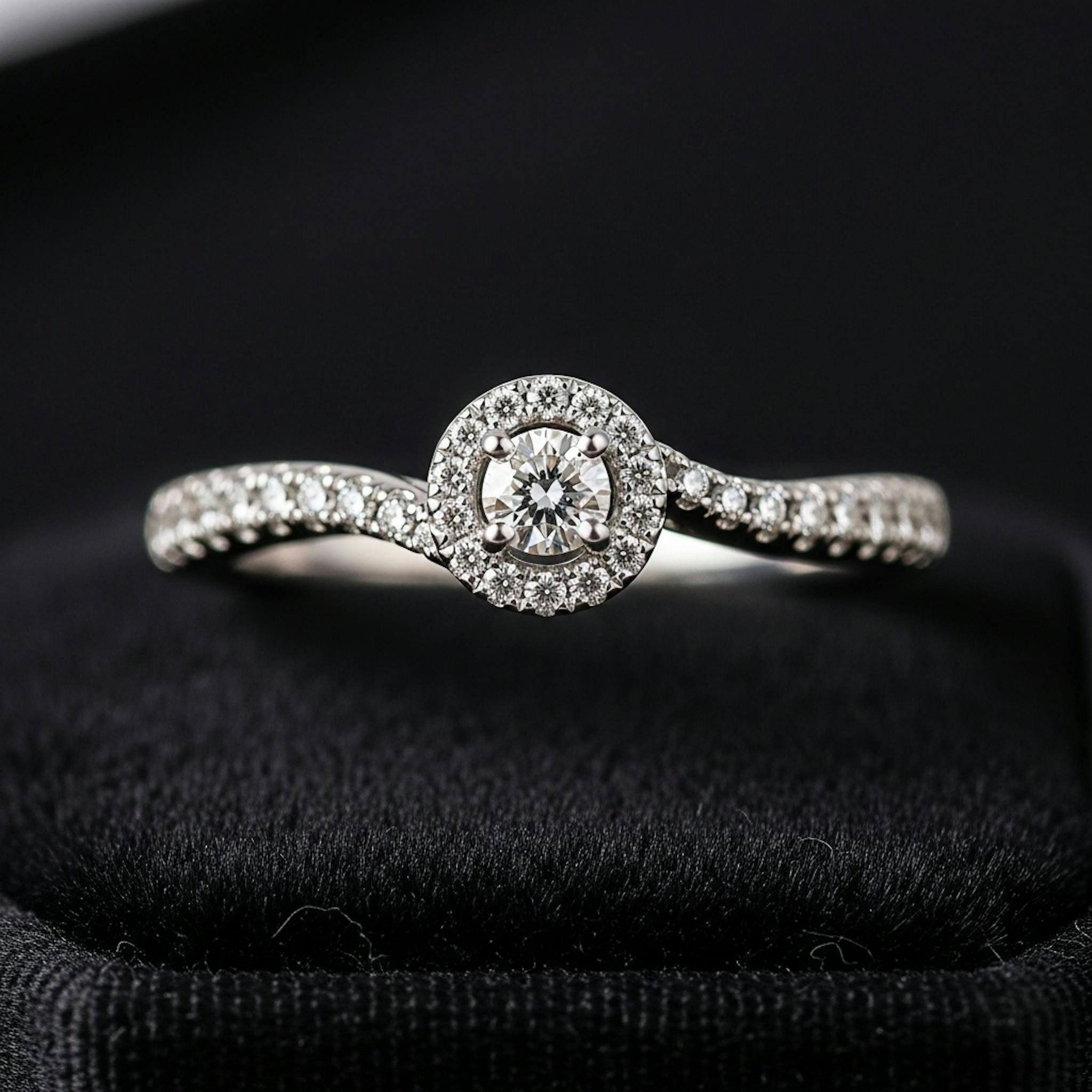 A small diamonds engagement ring with a curved pavé band