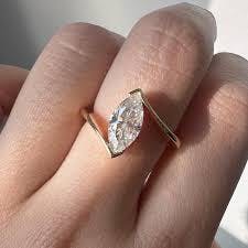 A minimal diamond ring with a tension setting.