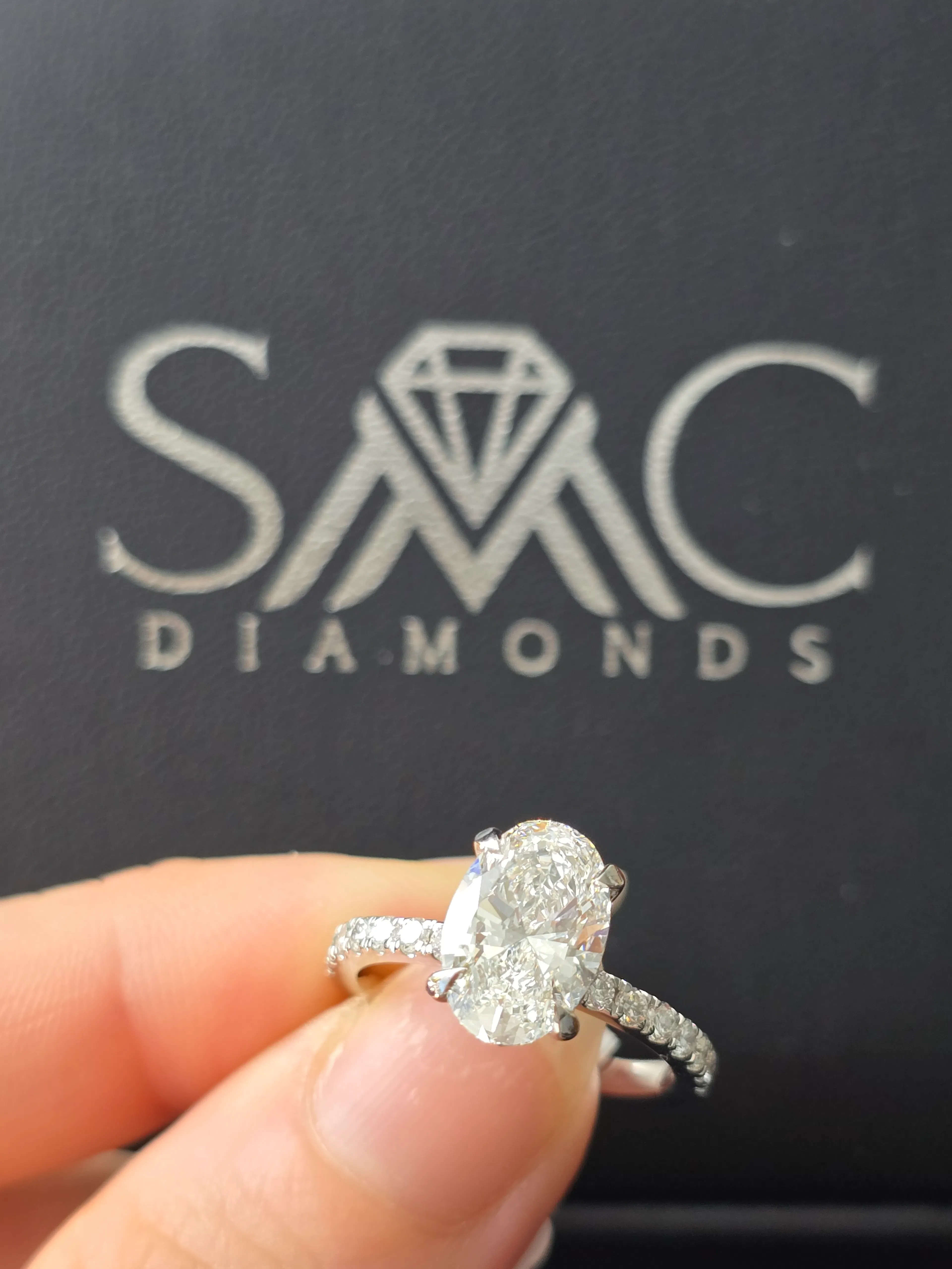 Oval diamond engagement ring with pavé band in 14K white gold at SMC Diamonds
