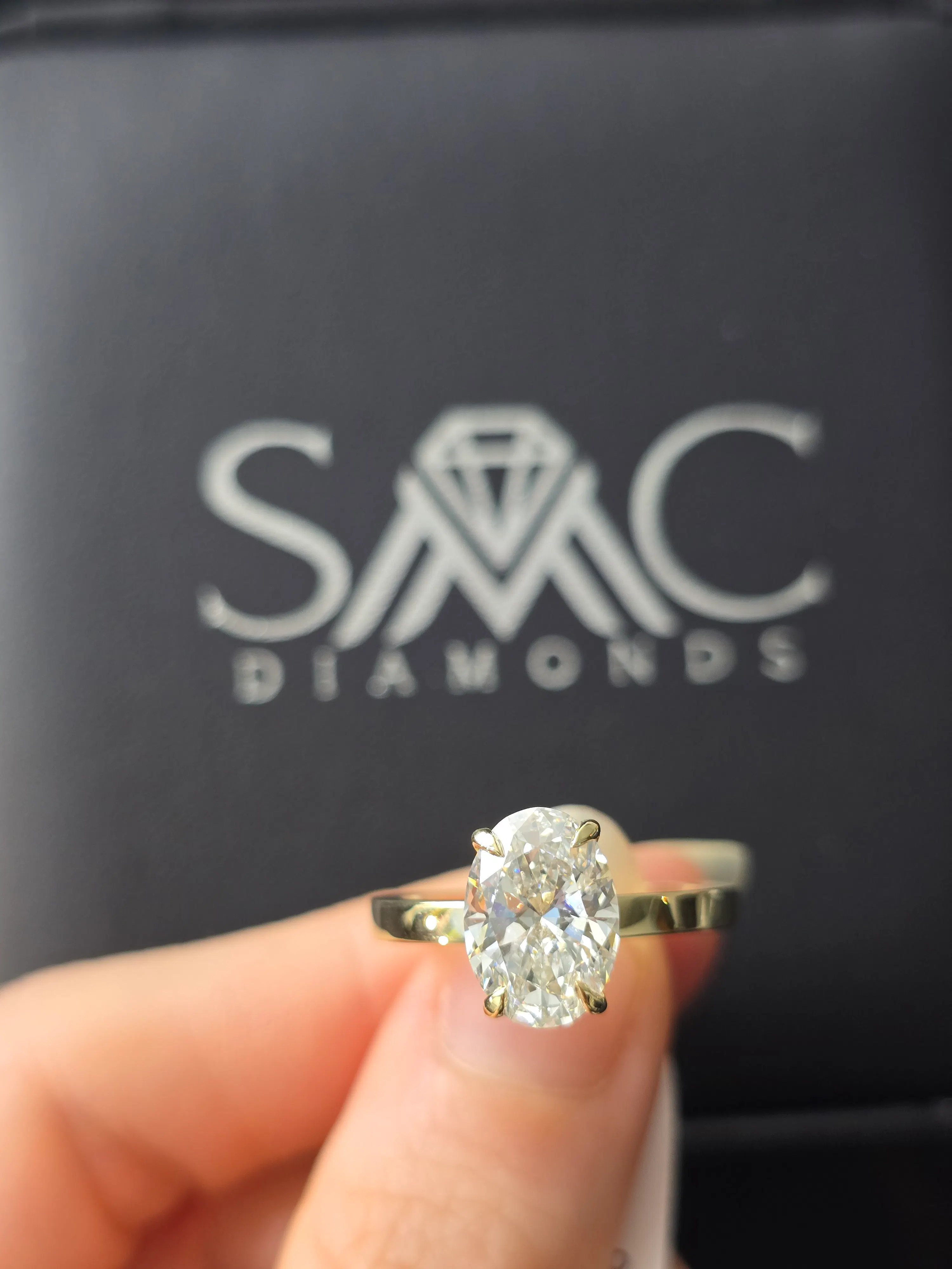 Oval solitaire diamond engagement ring in 14K yellow gold at SMC Diamonds