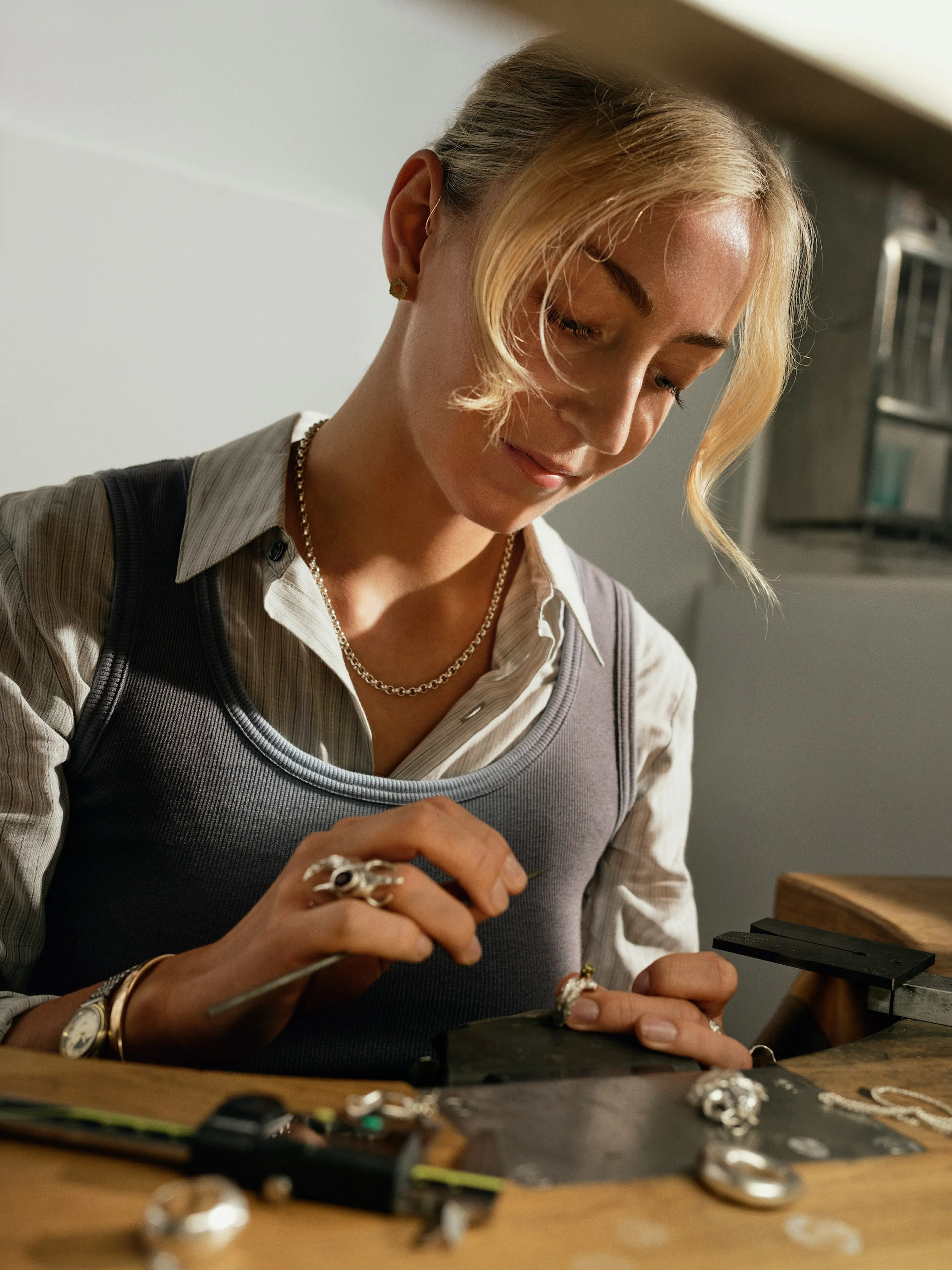 Jeweller crafting a custom engagement ring at a workbench