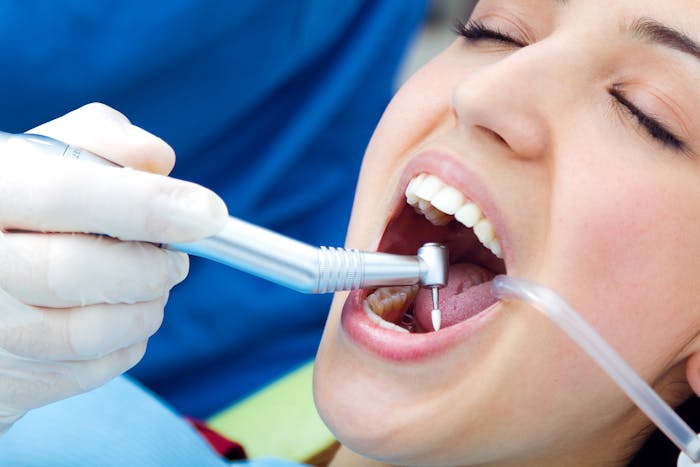 Doctor practicing teeth extraction on patient image