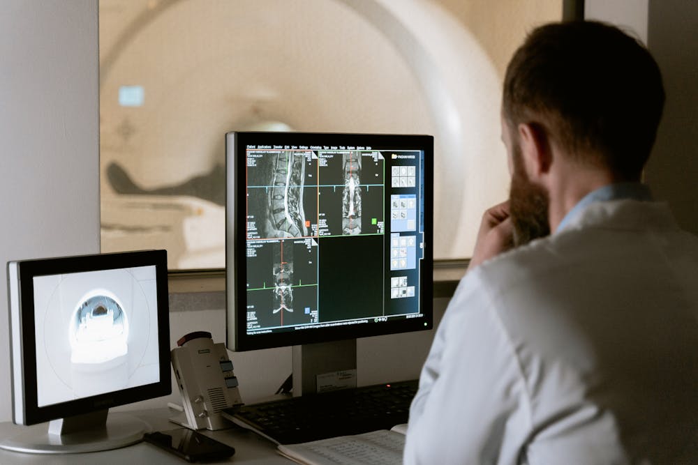 Doctor viewing CT scan report on computer