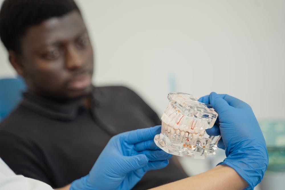 Doctor showing clear aligners to patient in dentistry clinic pic