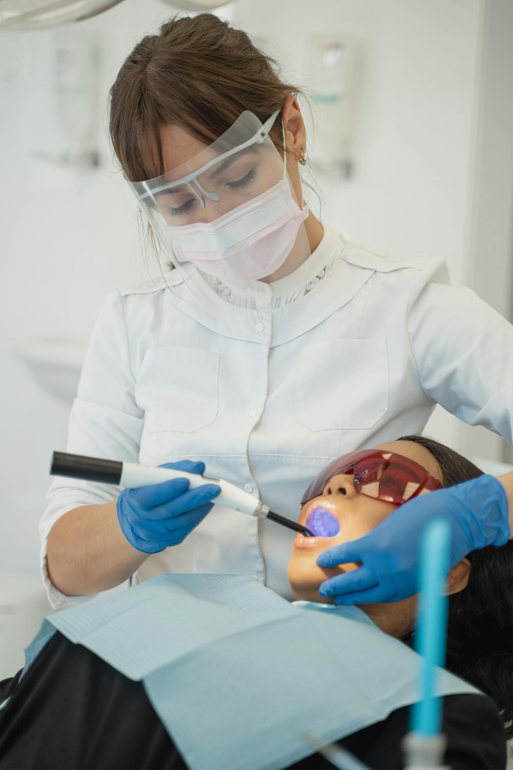 Dentist practicing root canal treatment on client pic