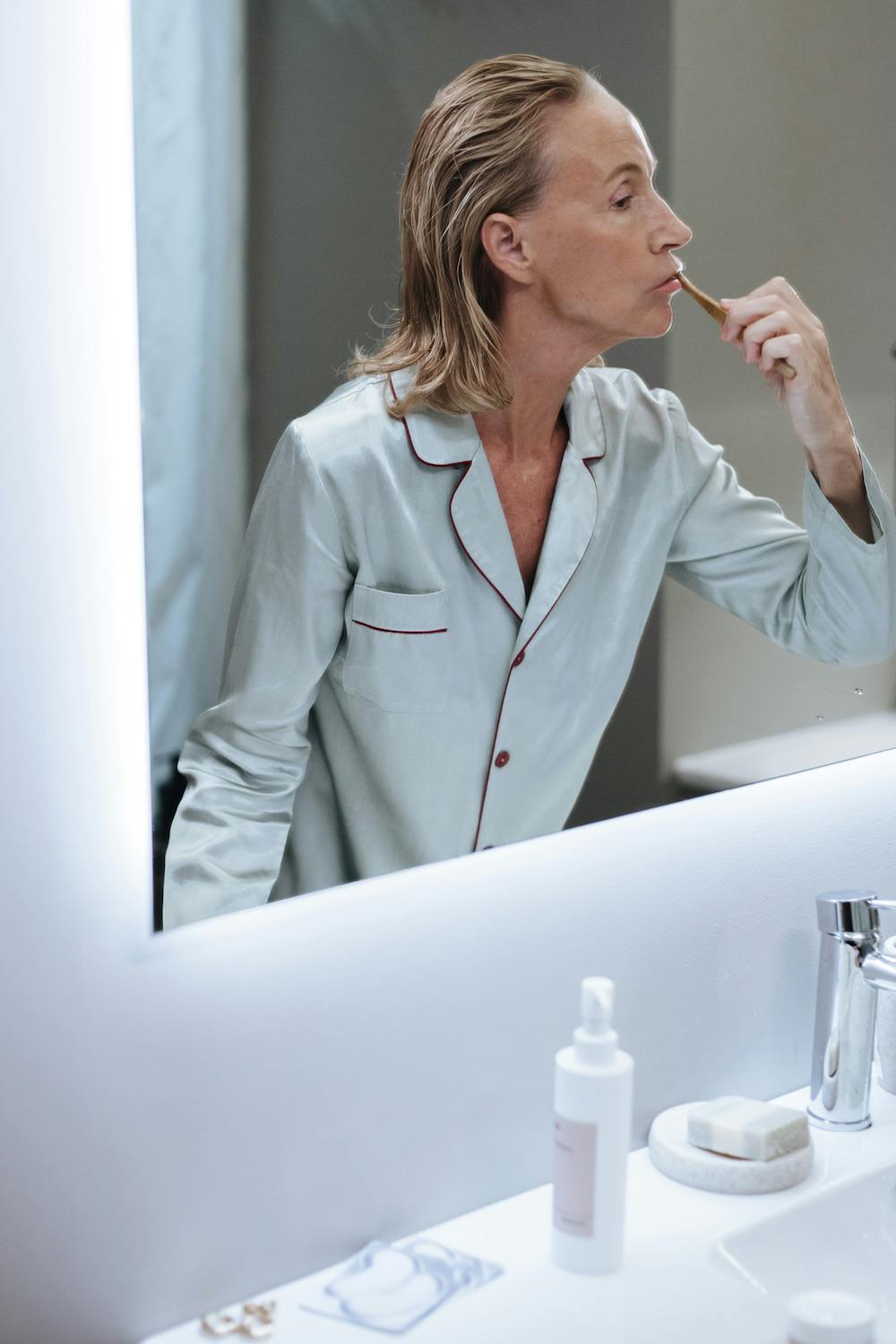 Woman brushing her teeth to care for oral hygiene