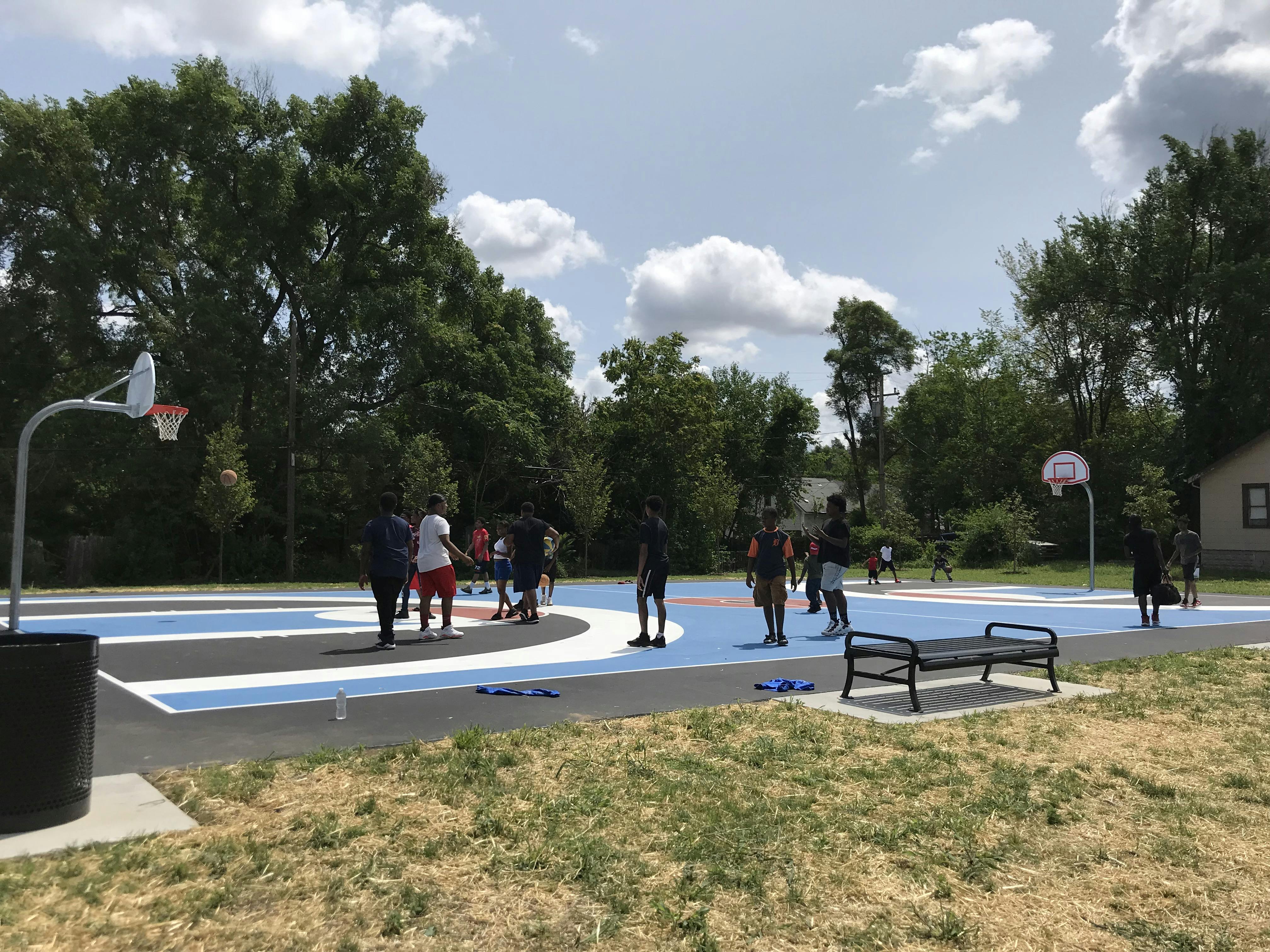 Constructed photograph of colorful basketball court with children playing basketball.