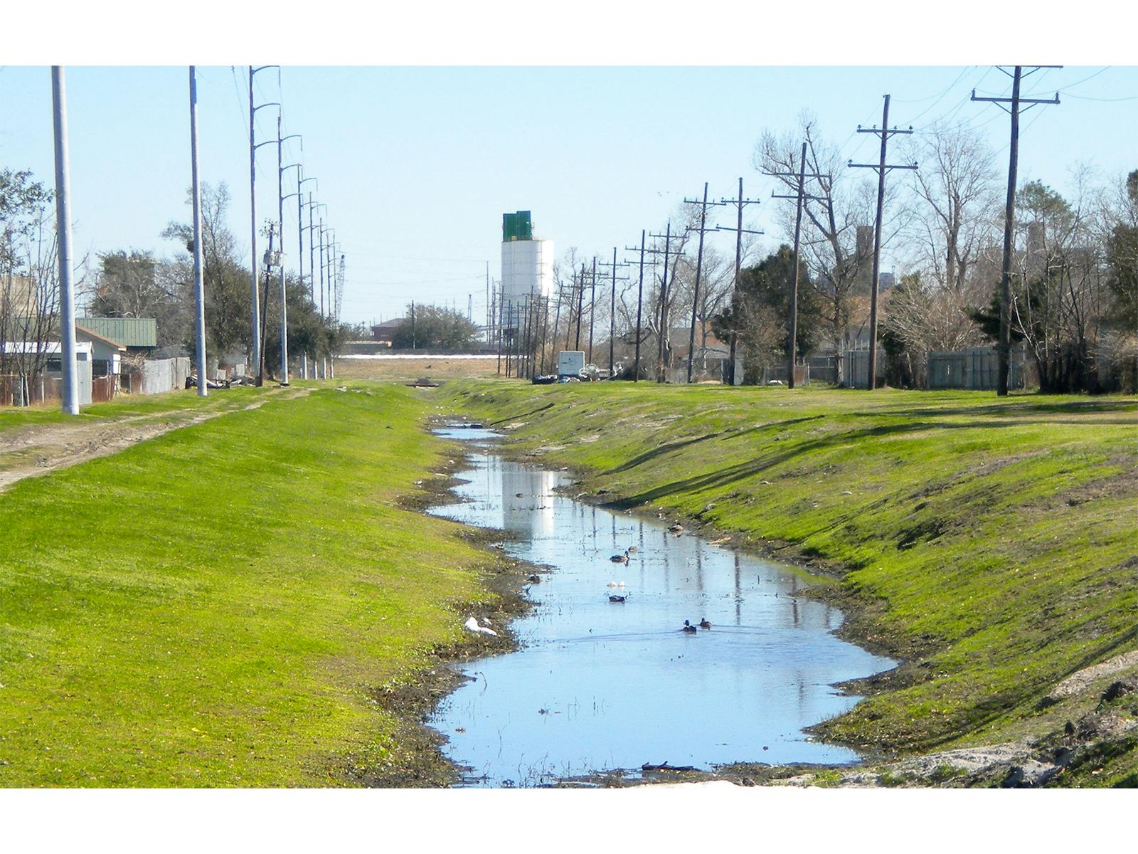 canal with a little bit of water in it and grass on the sides