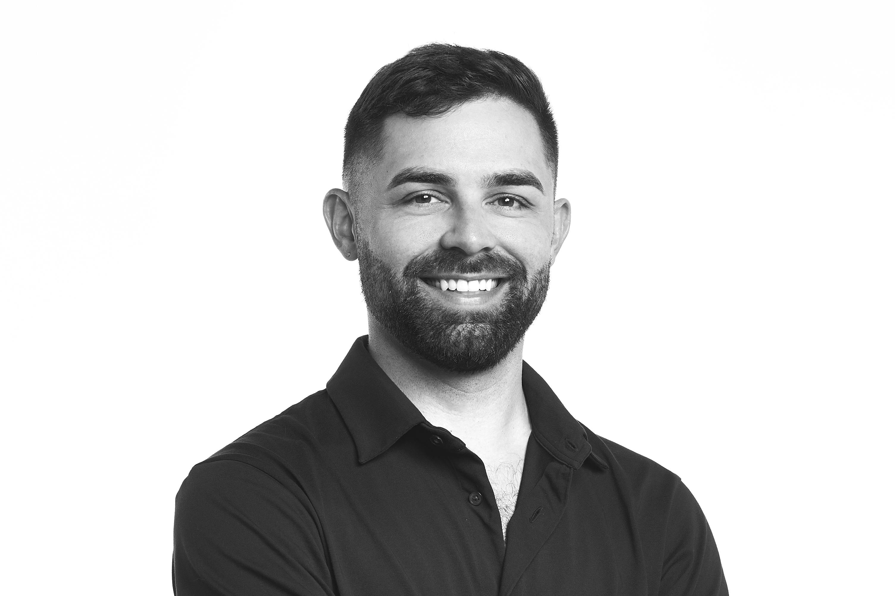 smiling man with short hair and black shirt