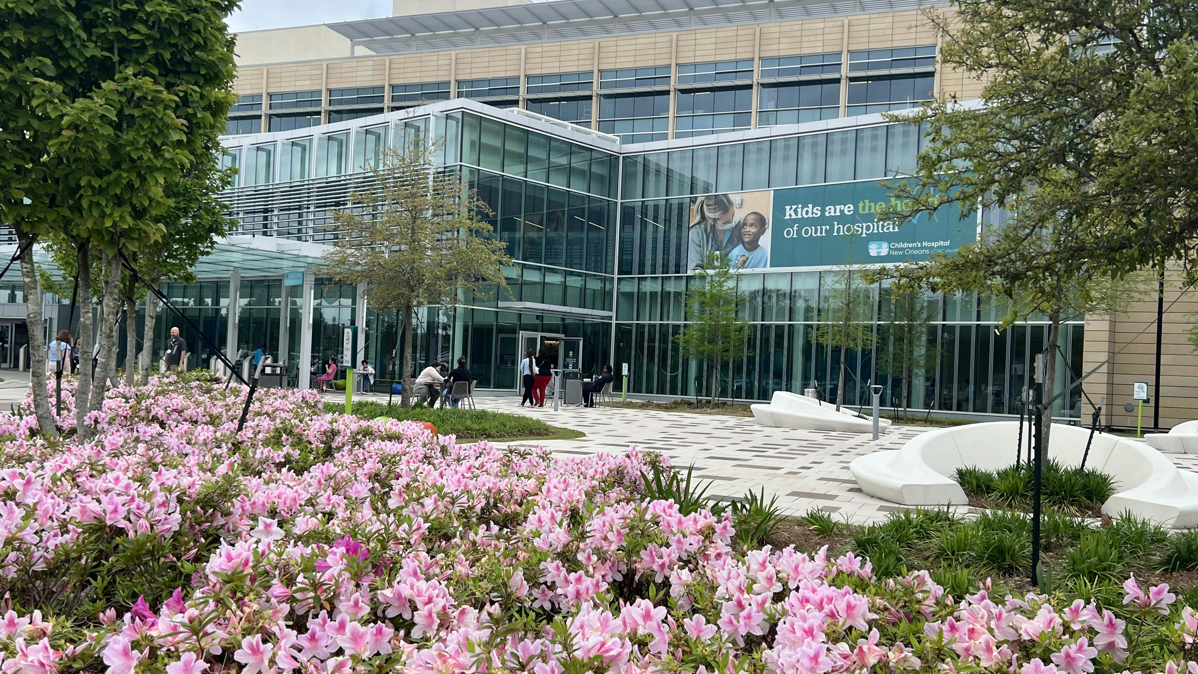 hospital entrance with flowers and trees