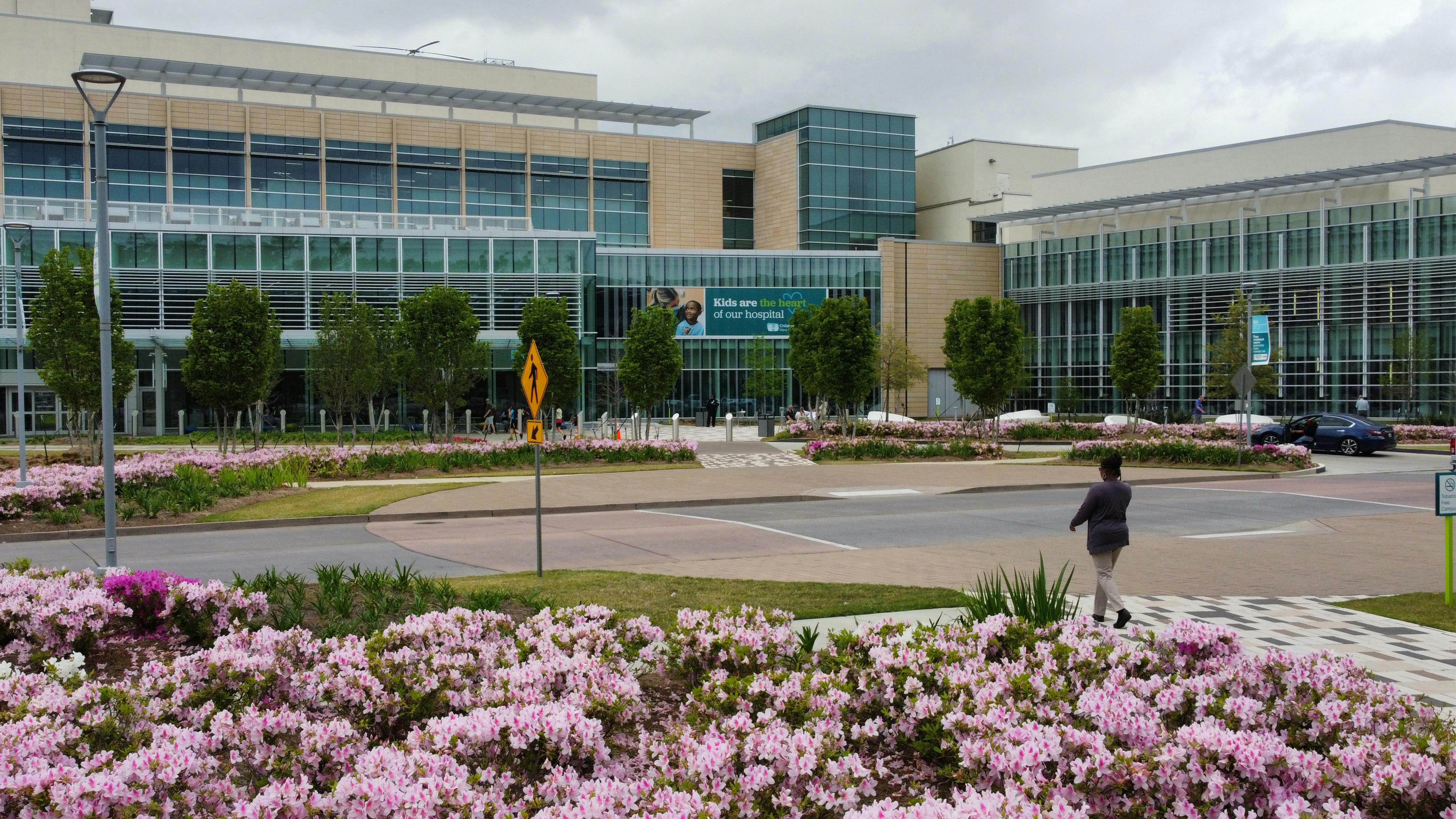 person crosses road at hospital entrance