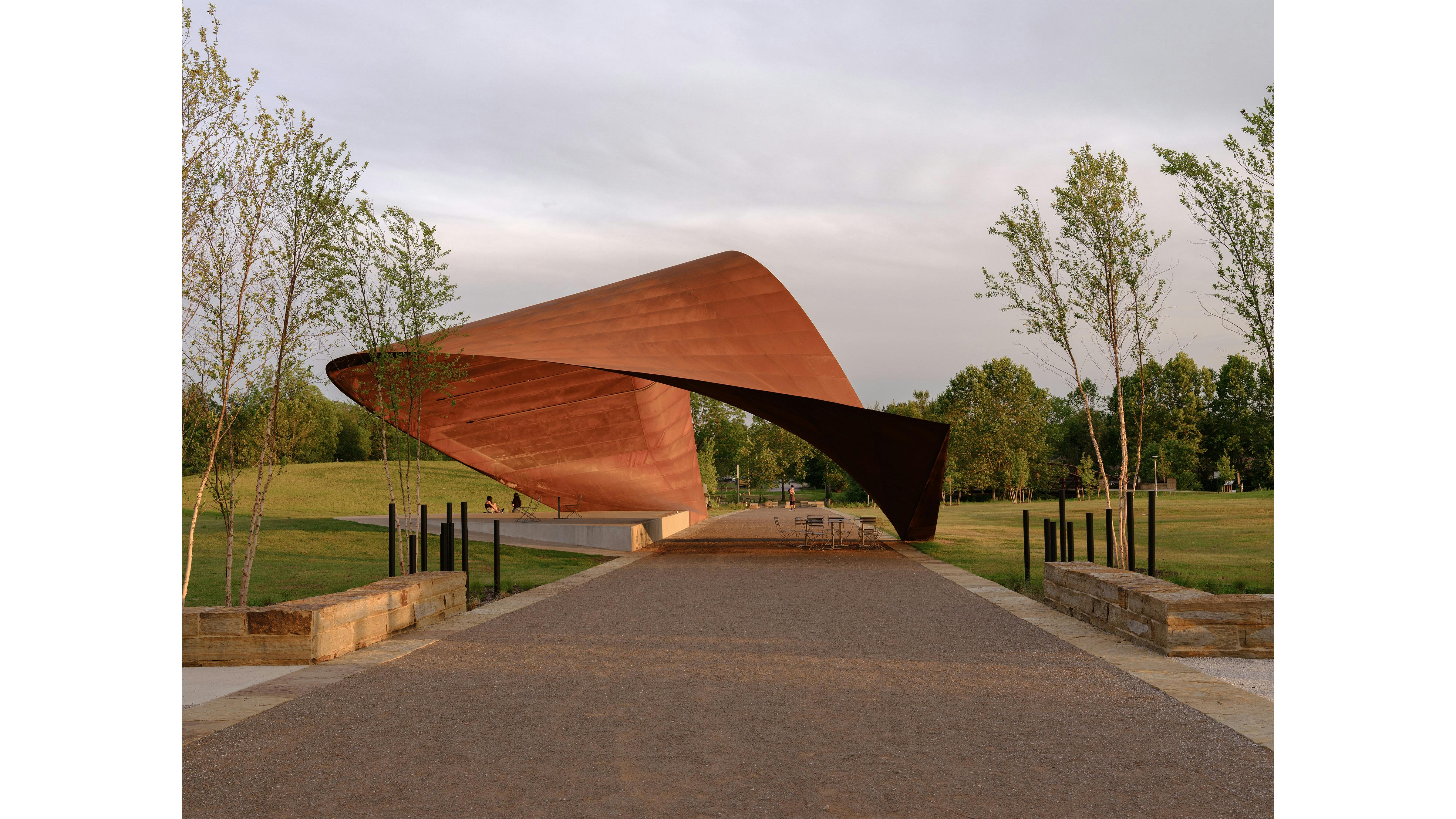 curved pavilion over park pathway