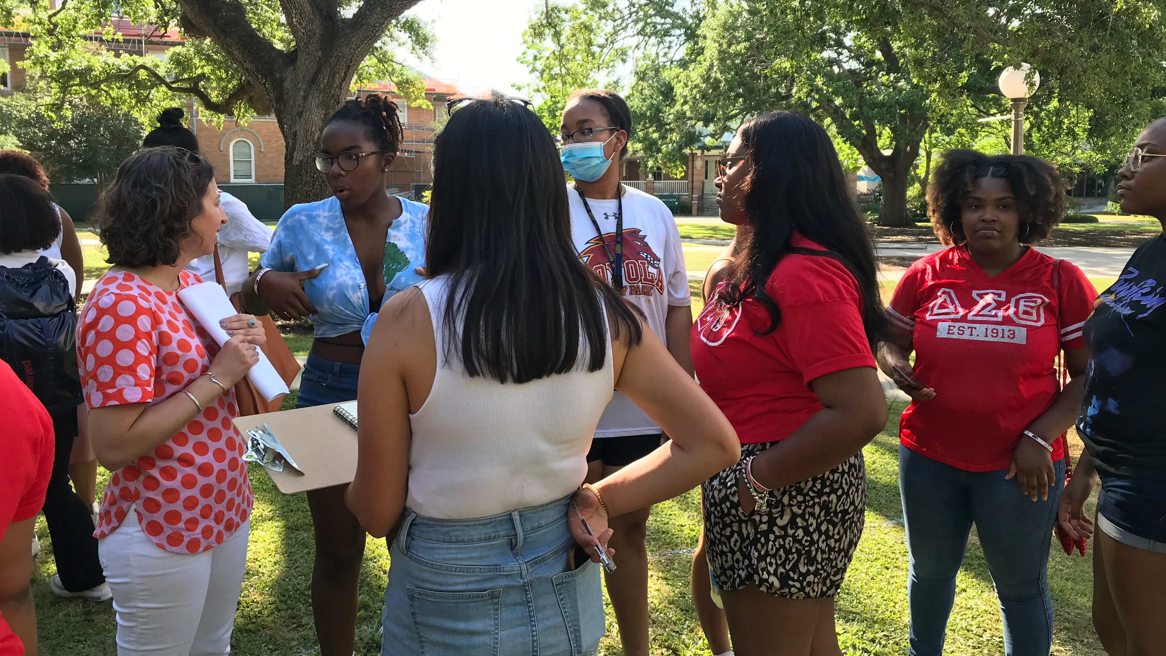 Members of Delta Sigma Theta Sorority Inc. gather with SMM designers to talk about the monument