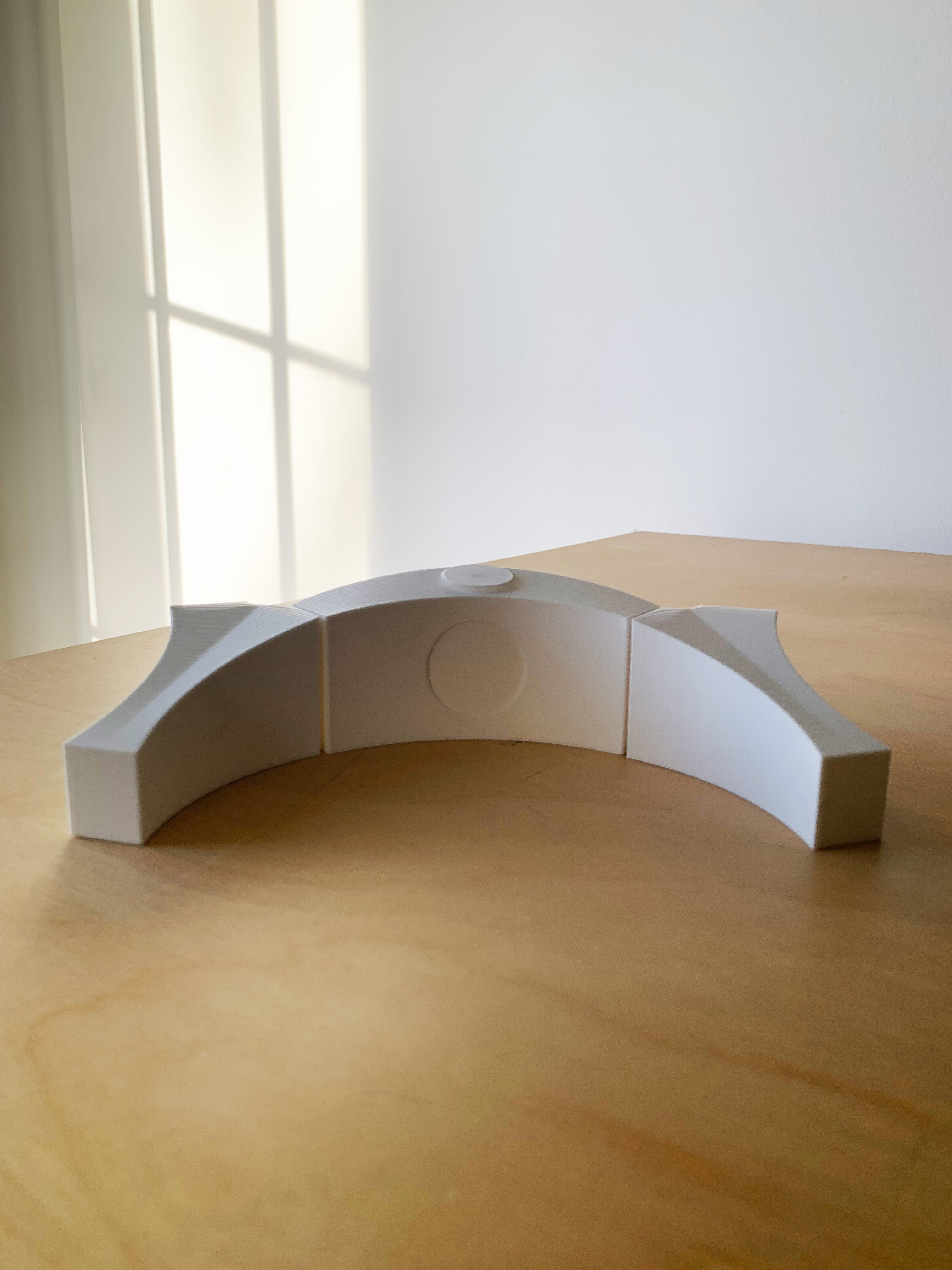 white 3d printed model of memorial on wooden table