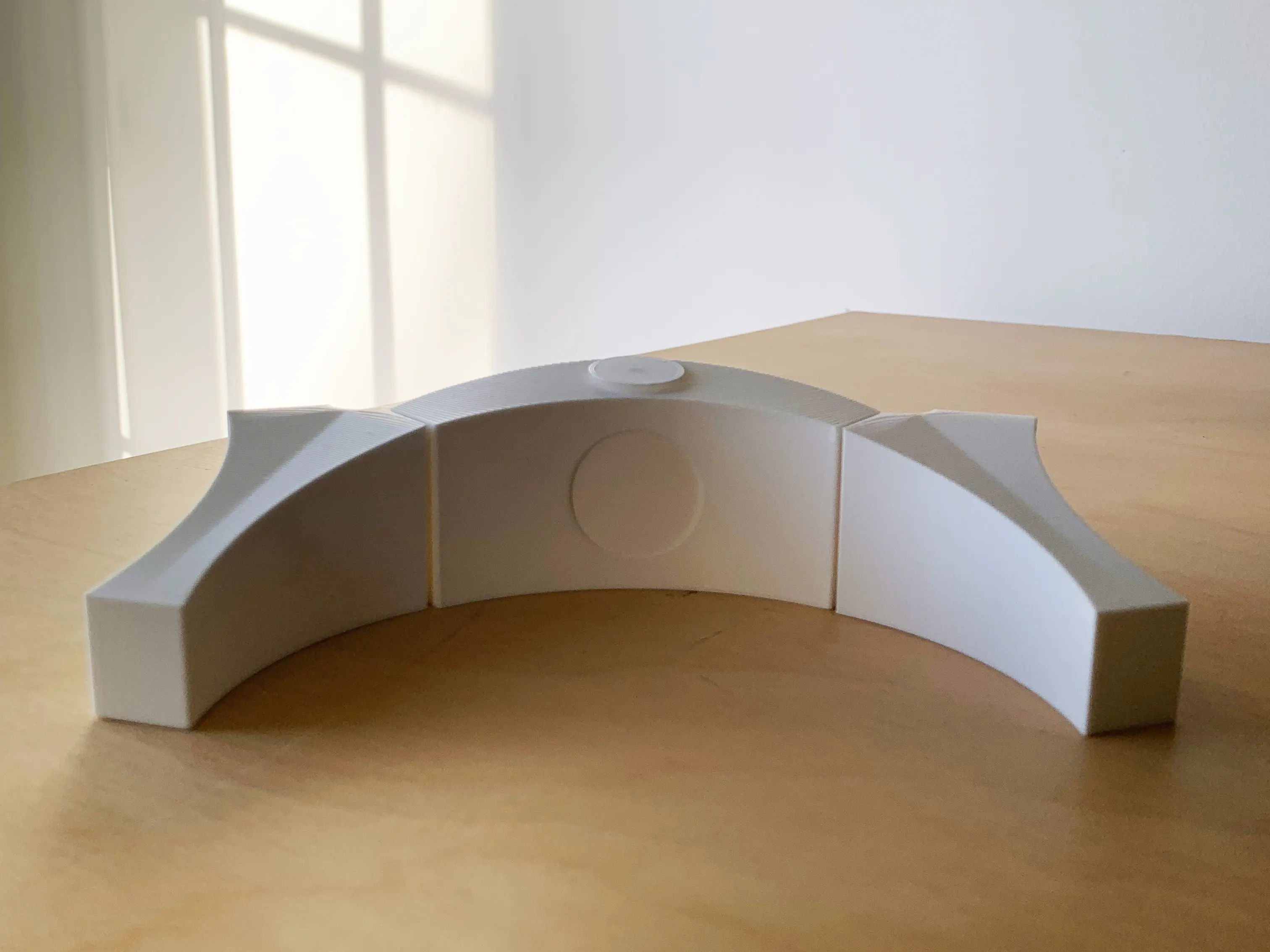 white 3d printed model of memorial on wooden table