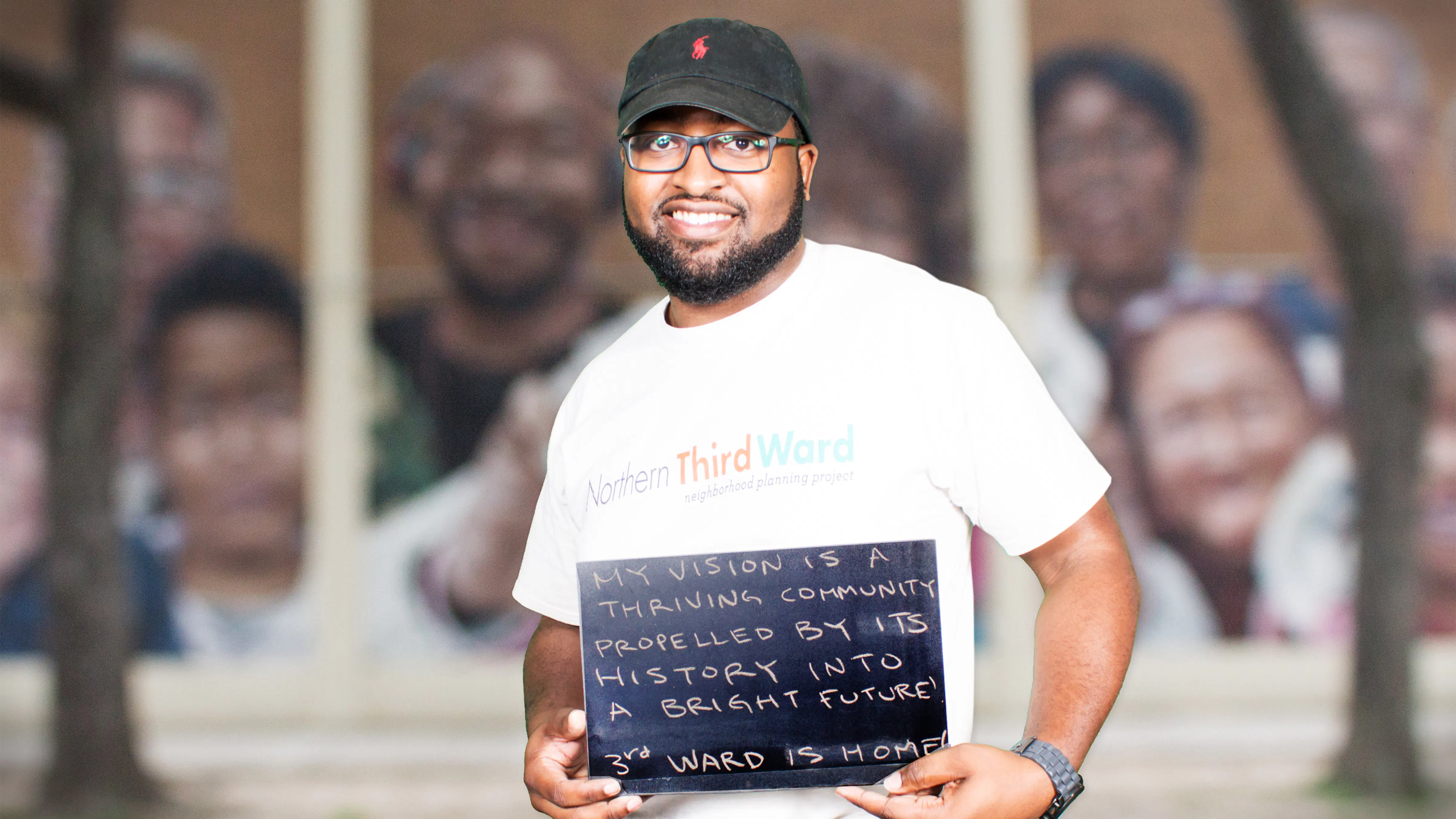 man in hat holding chalkboard and smiling