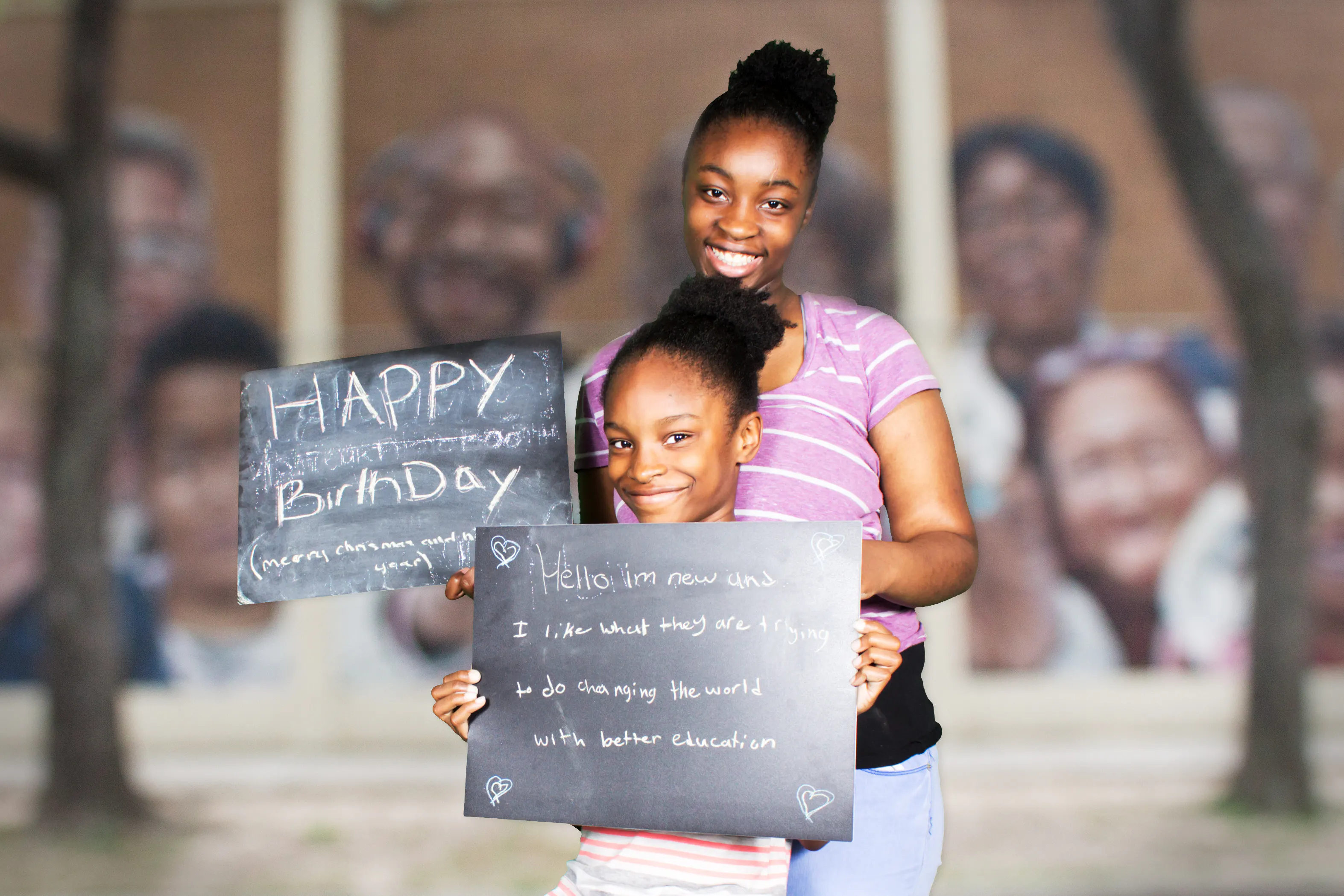 two young women holding chalkboards and smiling