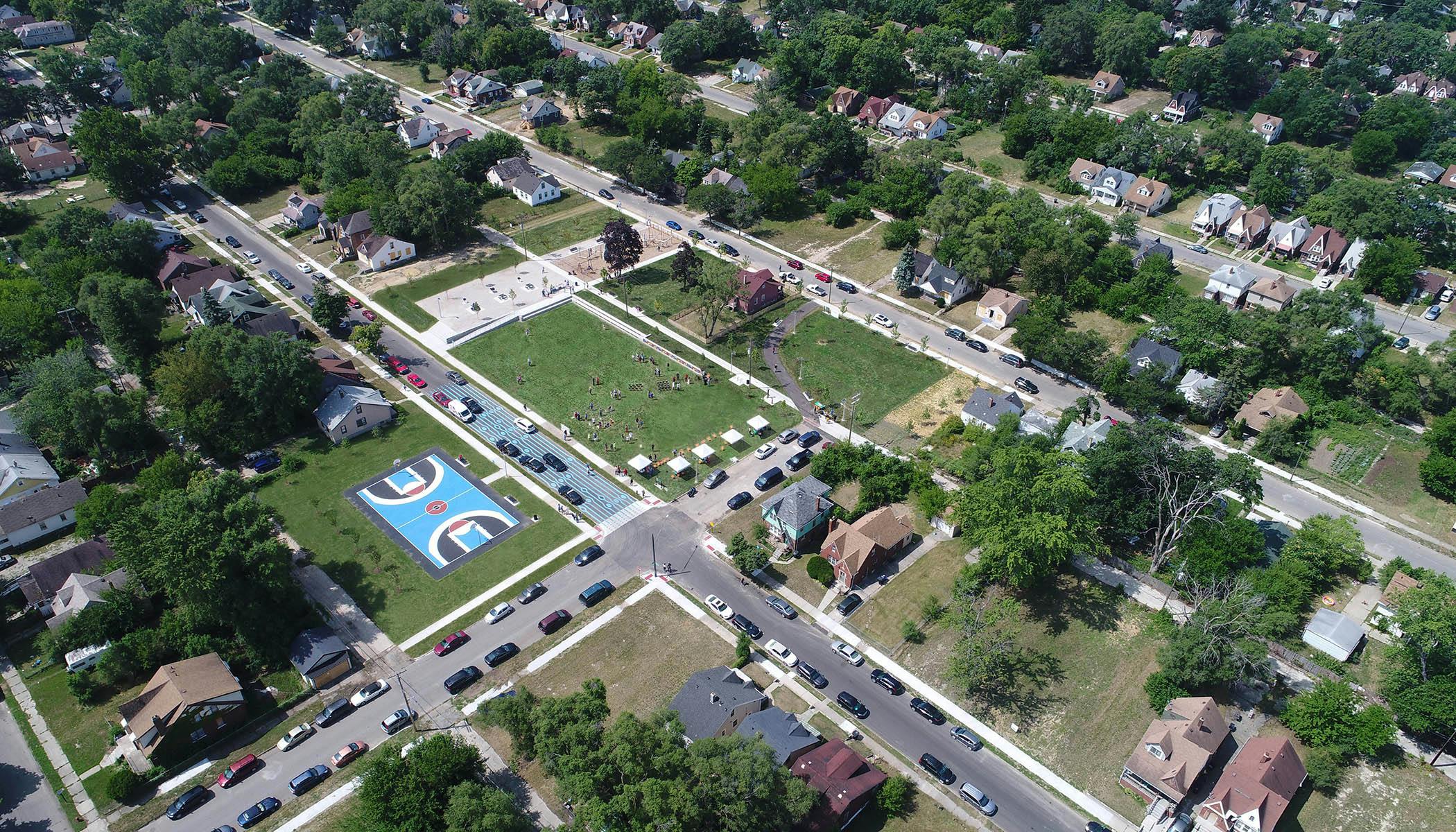 Bird's eye view constructed photograph of the central park, Ella Fitzgerald Park, with colorful basketball court, future greenway, and artistic crosswalk as a street calming measure.