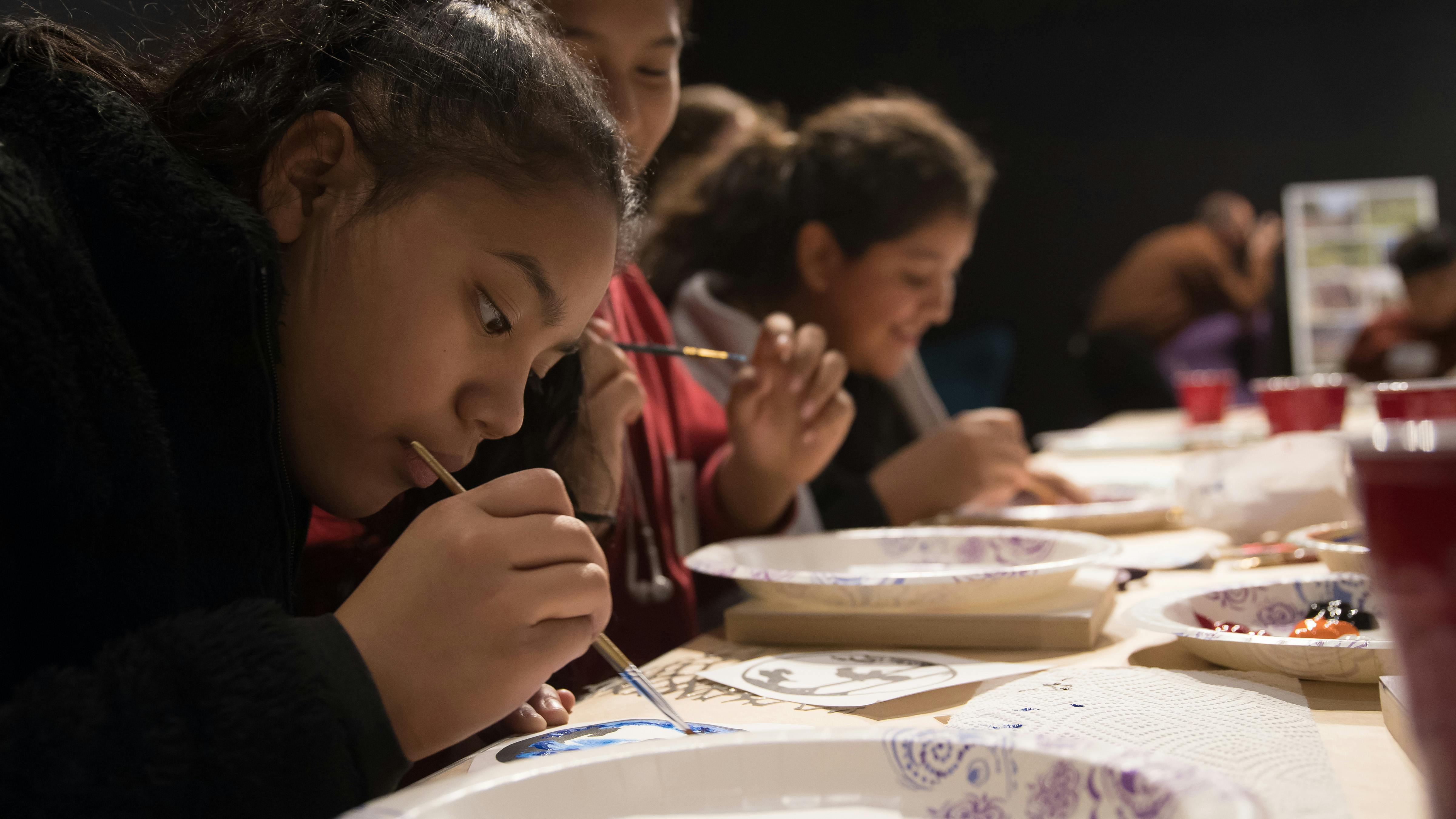 Youth members of Springdale community painting a tile that represents their vision for Luther George Park.