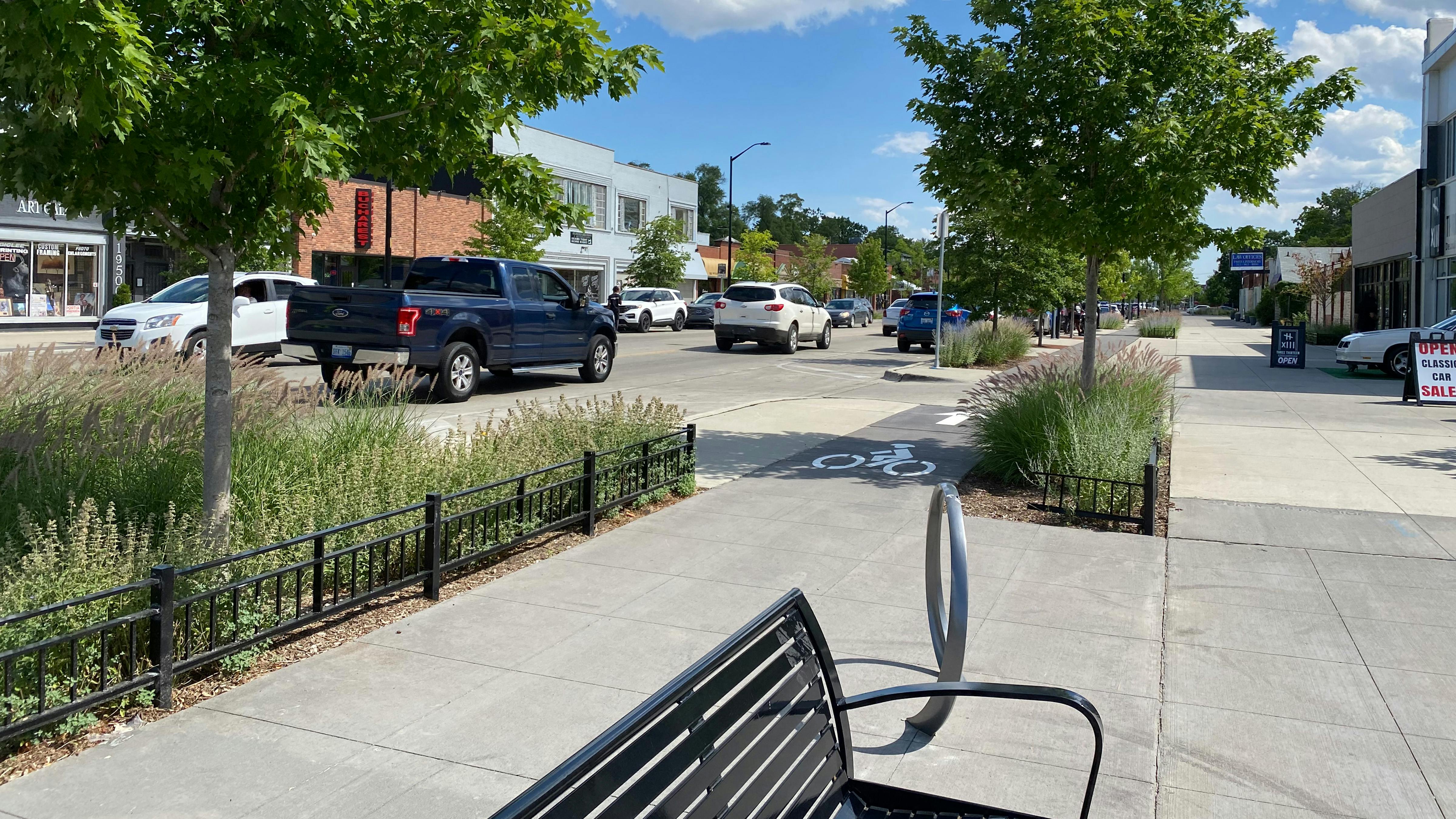 Installed photography of bike lane and multiple planting beds dividing roadway and bikelane from pedestrians.