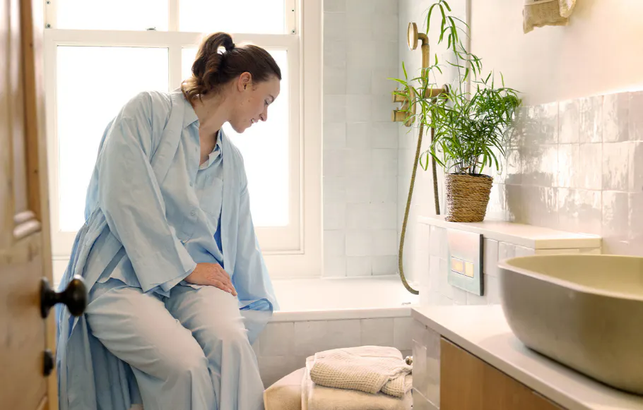 Woman enjoys mindful moment with Bathroom Reset