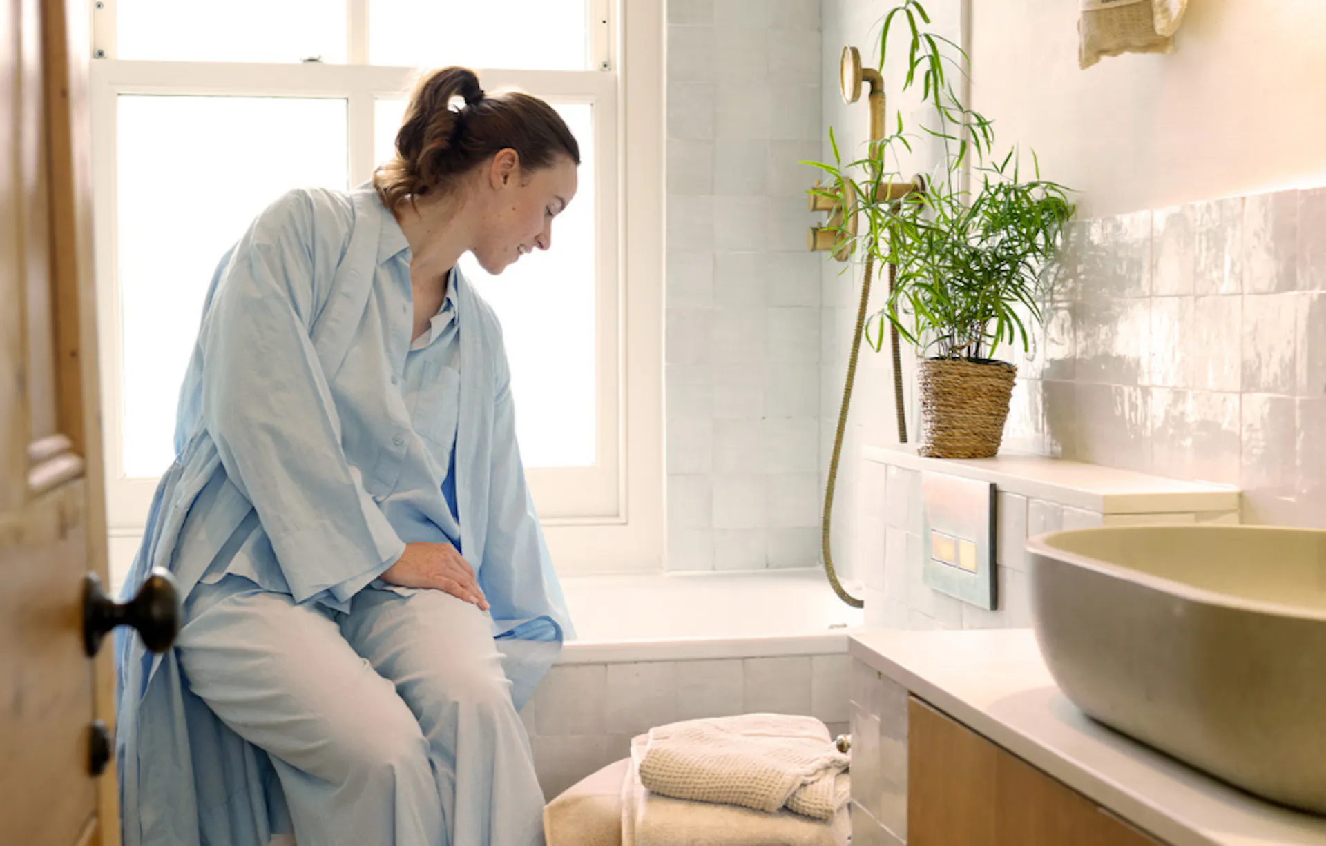Woman enjoys mindful moment with Bathroom Reset