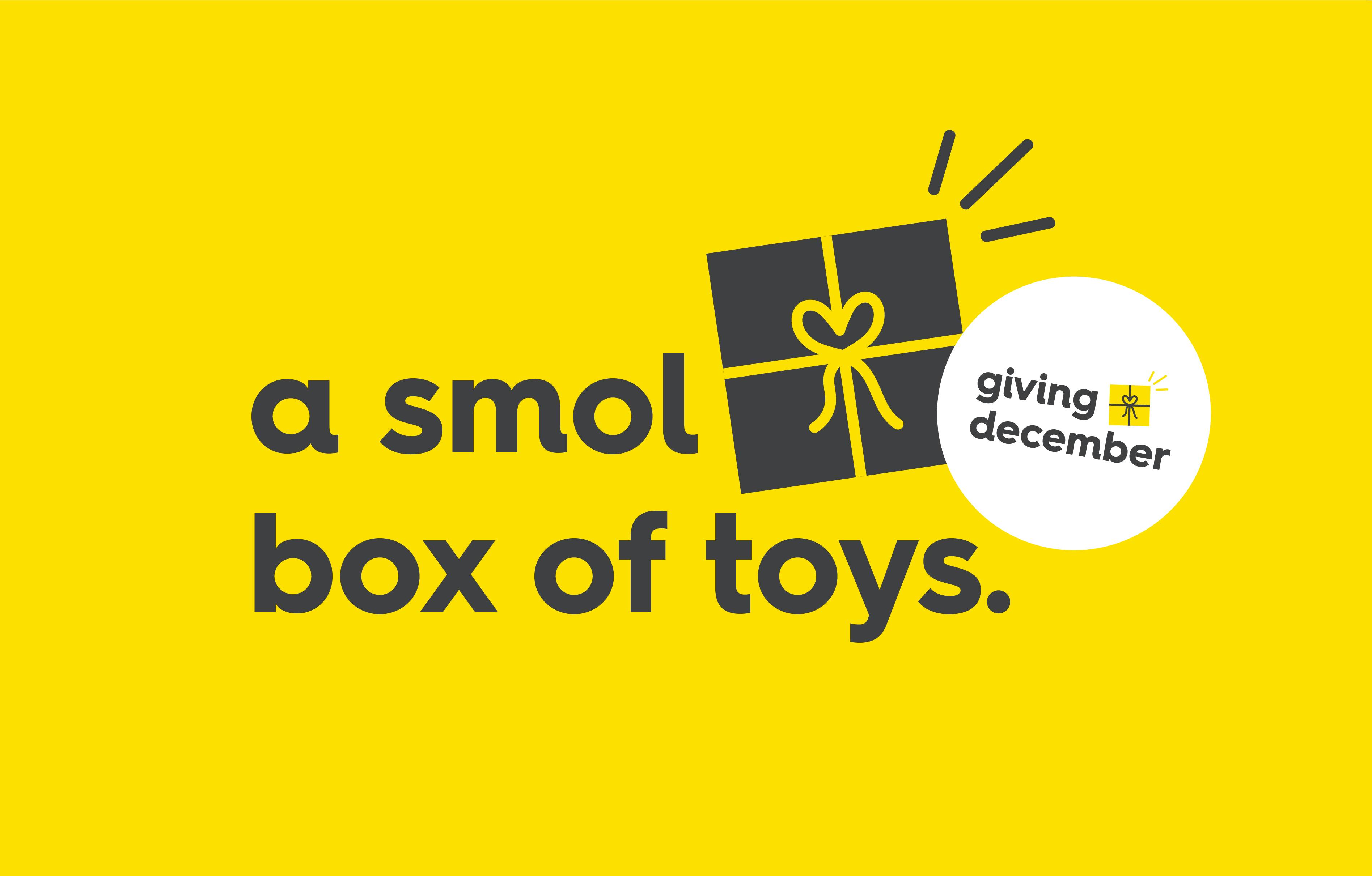 text on yellow background with gift illustration and a roundel. text background: smol box of toys, text roundel: giving december