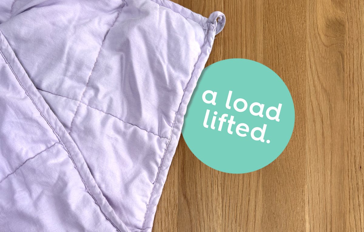image of a weighted blanket on a wooden floor. text: a load lifted.
