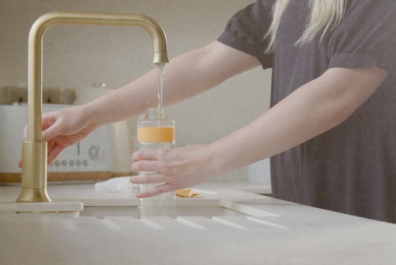 smol multi purpose spray bottle being filled with water