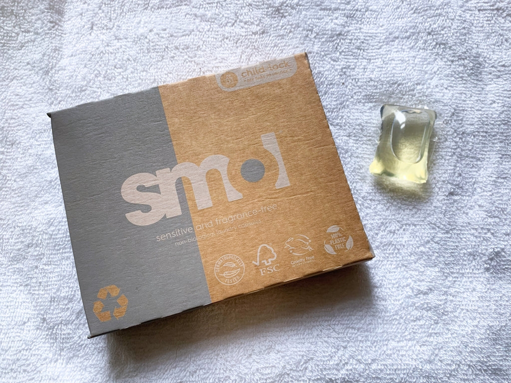 smol fragrance free laundry capsule alongside its packaging