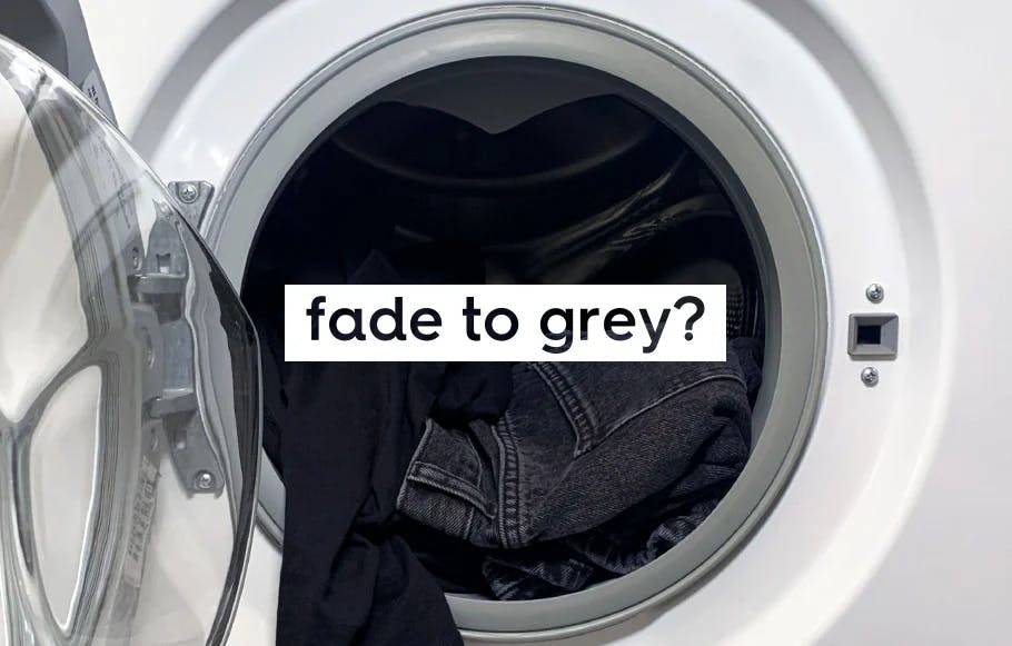 close up of open washing machine door with black laundry inside. text: fade to grey?