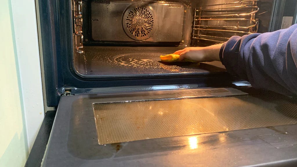 wiping the inside of a microwave