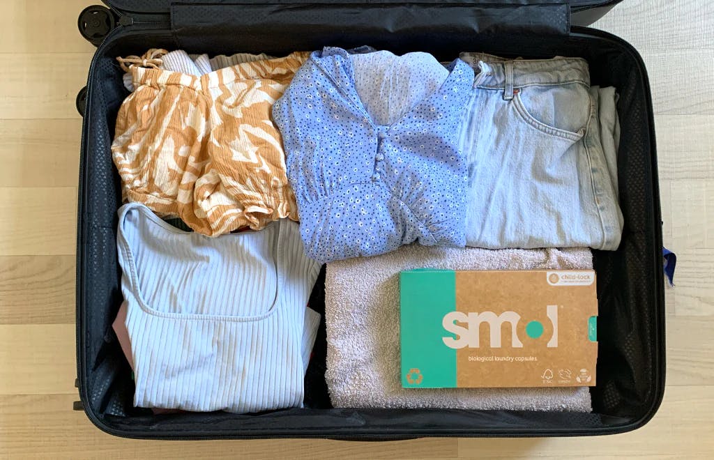 smol capsules in a suitcase with clothes