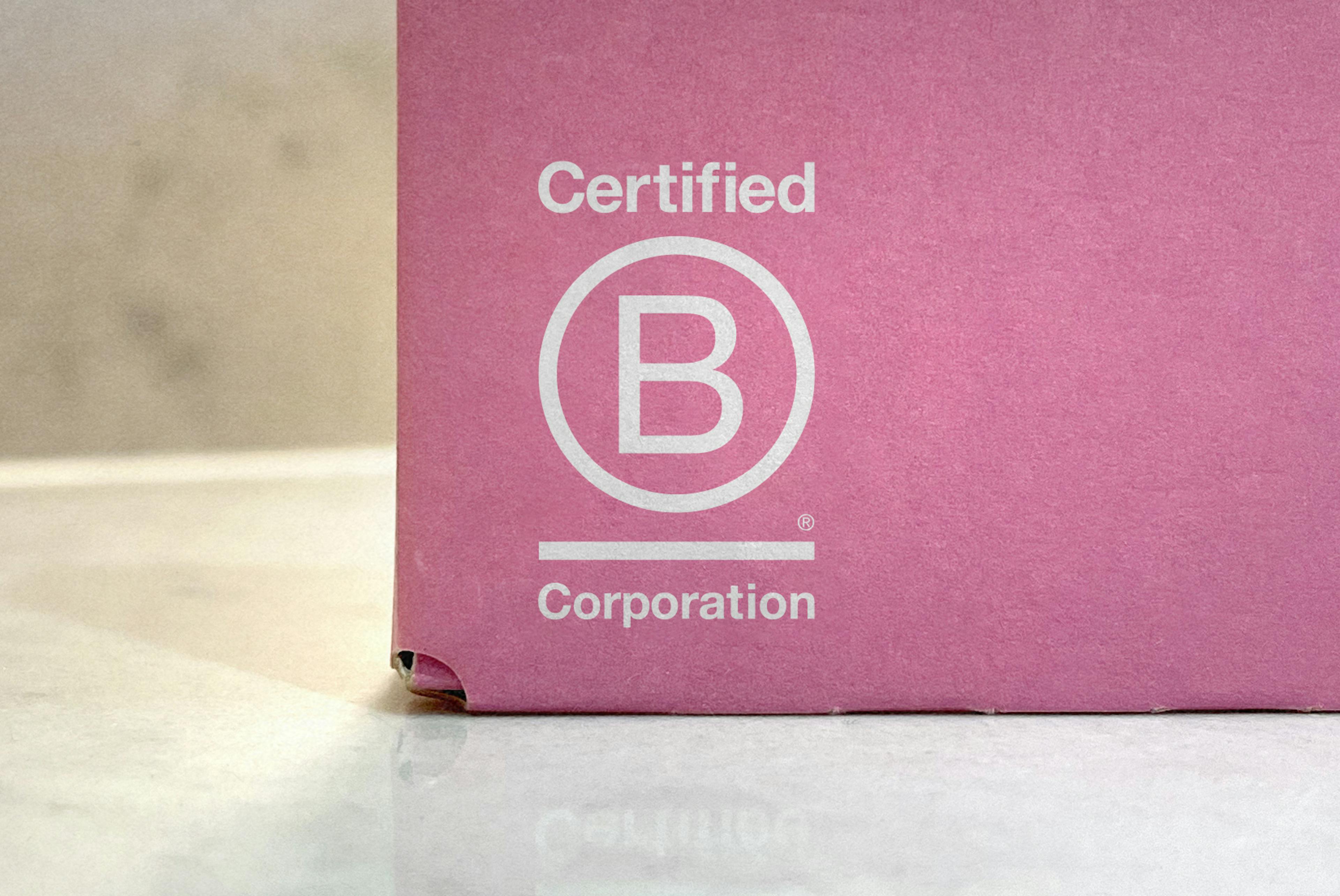 pink cardboard box printed with bcorp logo