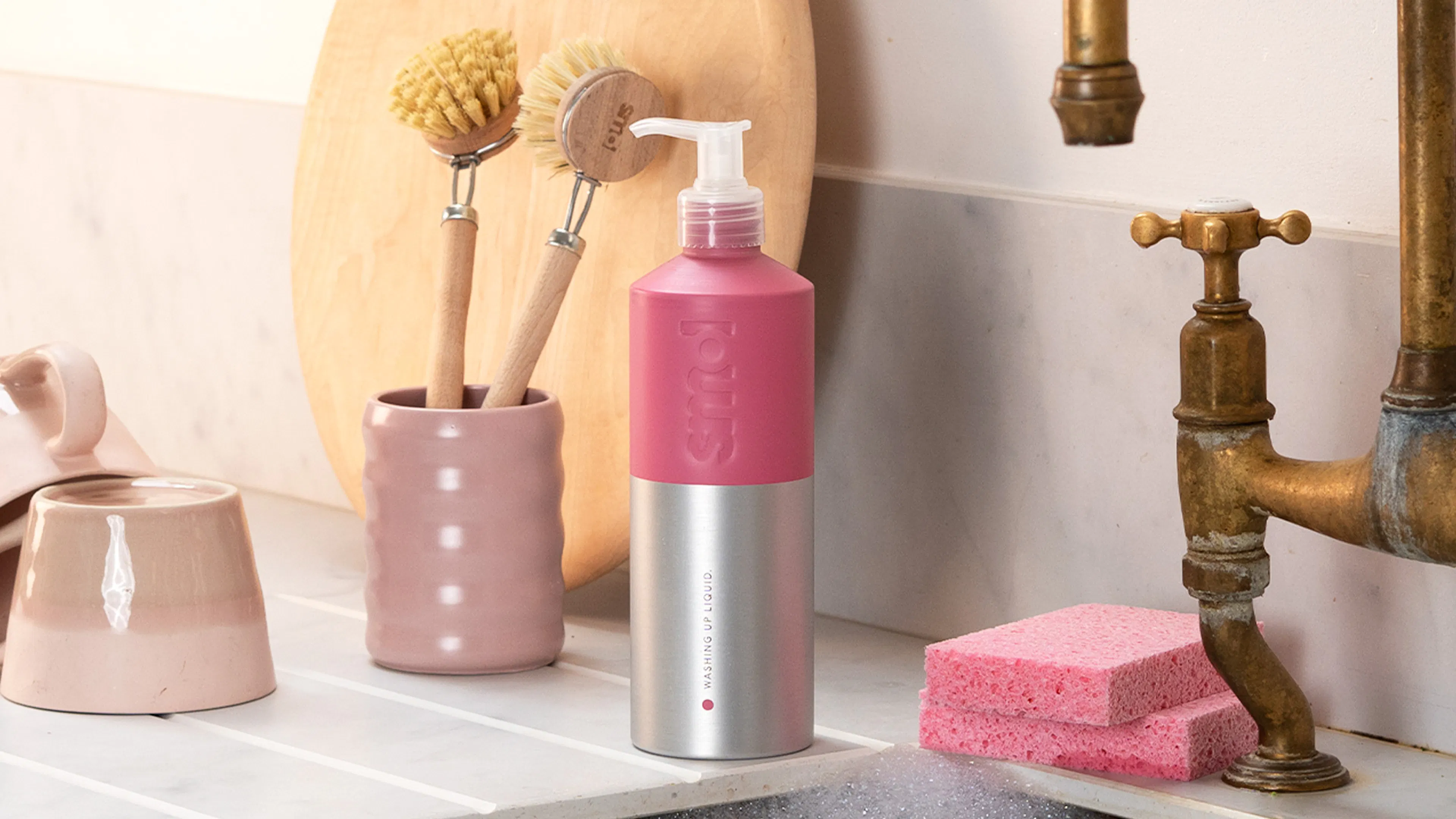 smol's washing up liquid aluminium bottle  placed beside a kitchen sink