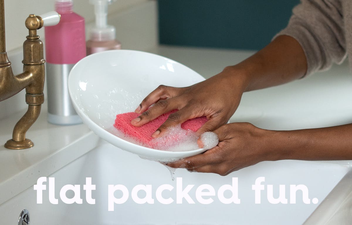 image of some washing up dishes with pink sponge and text overlay, text: flat packed fun.