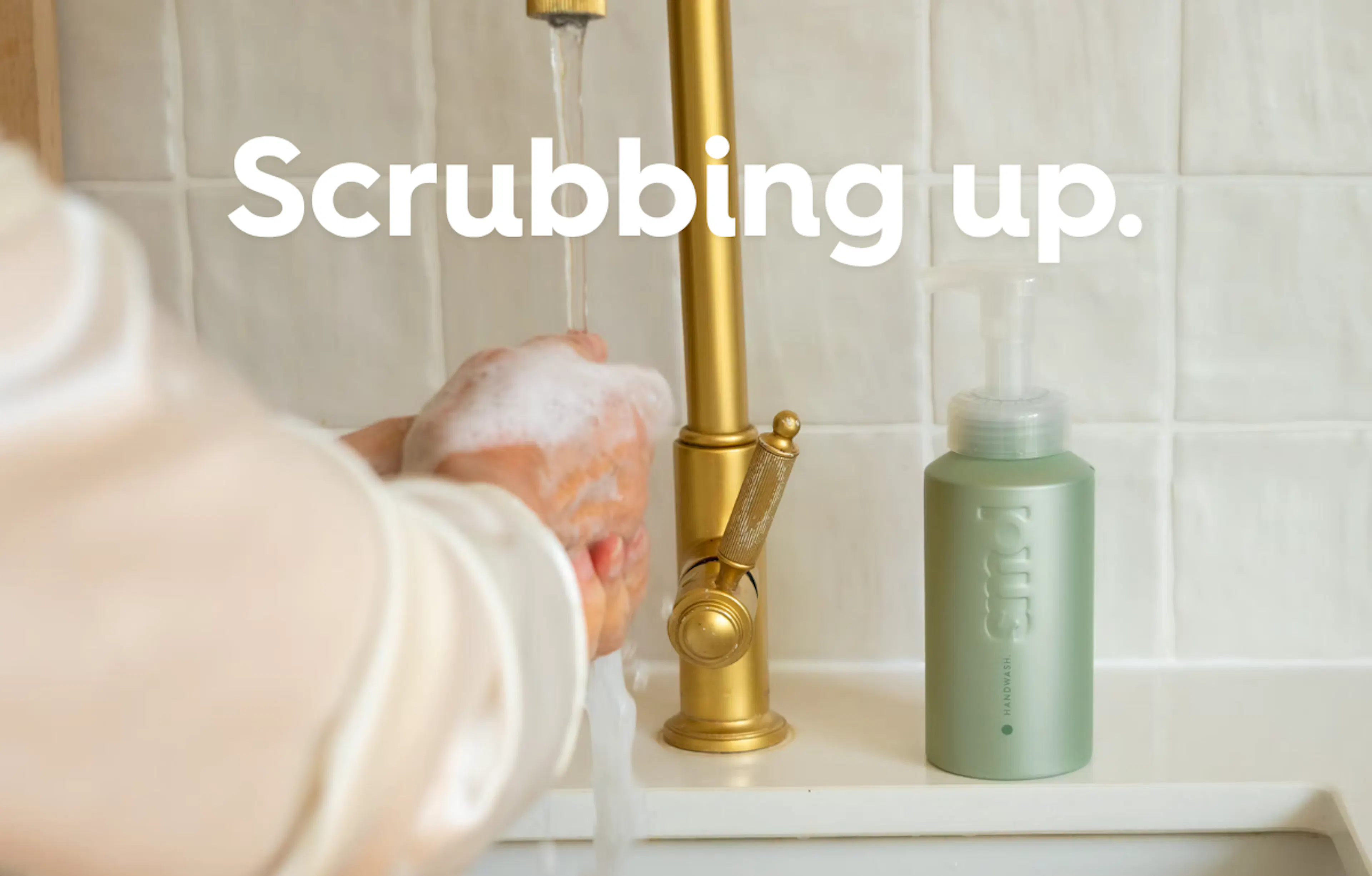 person washing their hands with smol handwash, text reads: scrubbing up. 