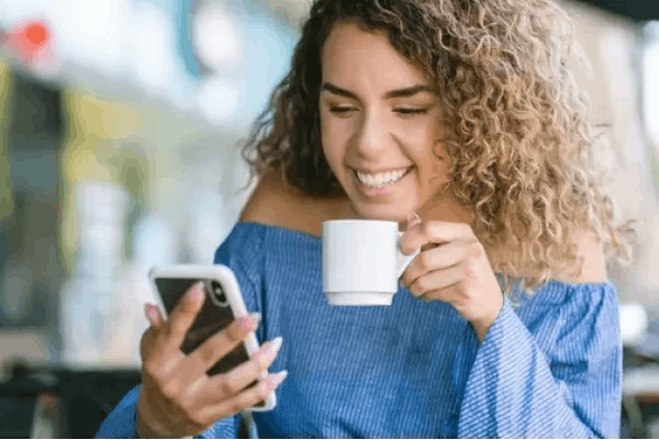 Woman at the phone taking a brew
