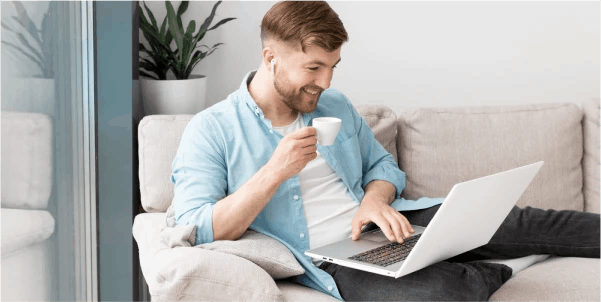 Man sitting on sofa with laptop