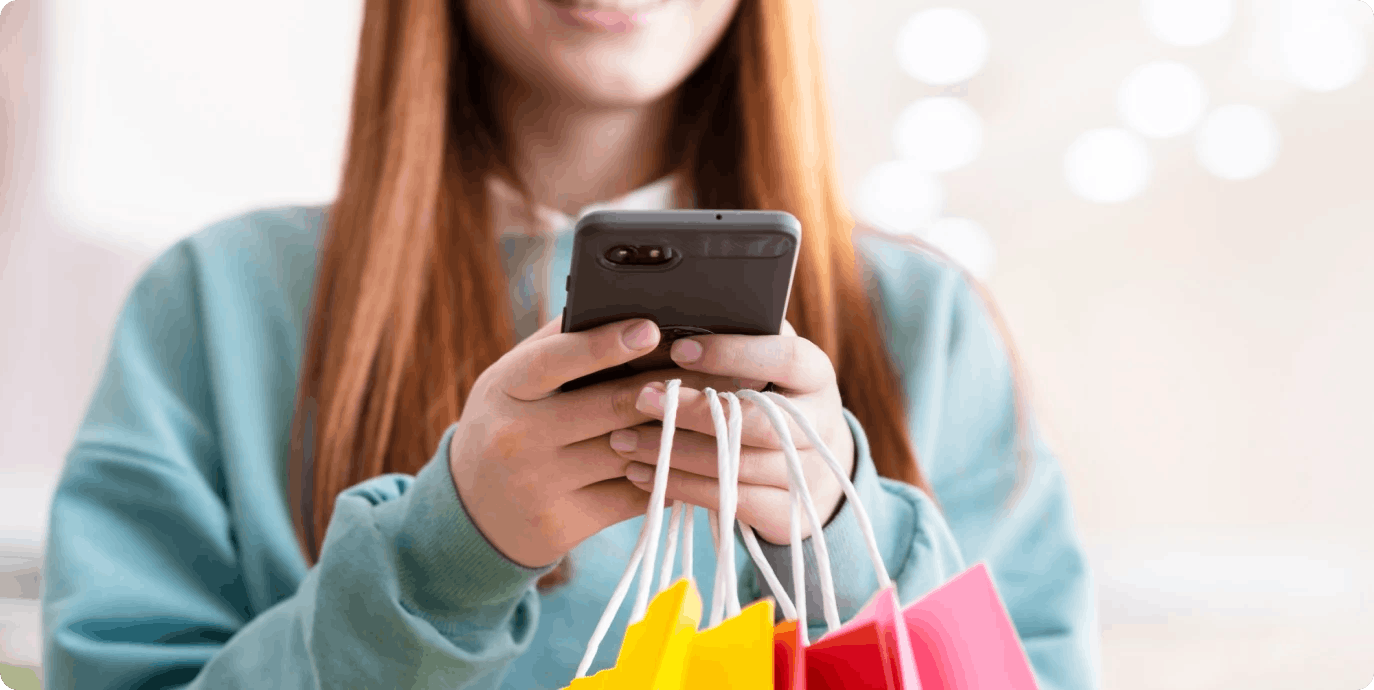 Women with phone and shopping bags