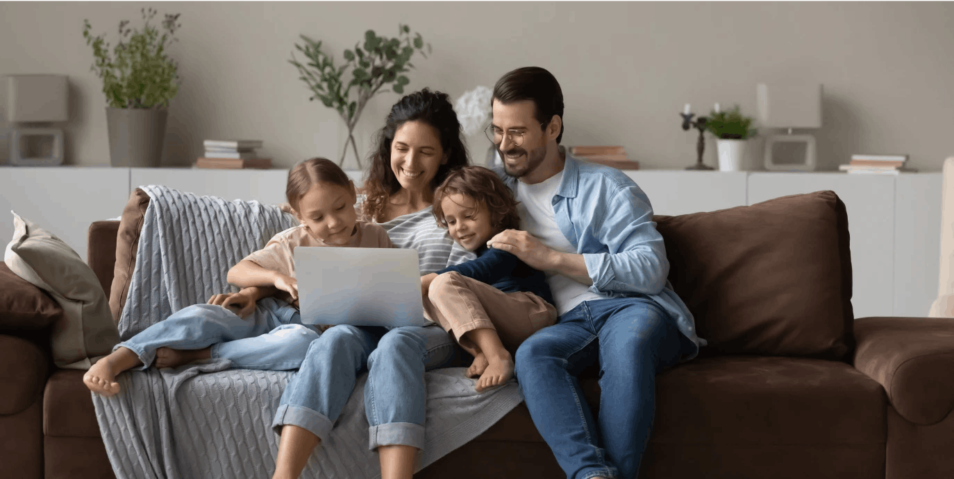 Family looking at laptop