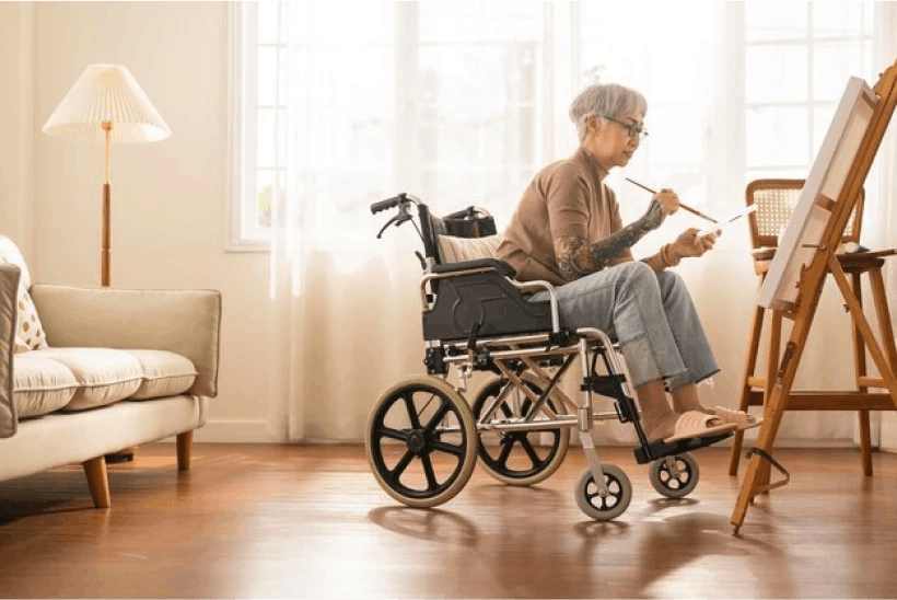 Woman painting in a weelchair