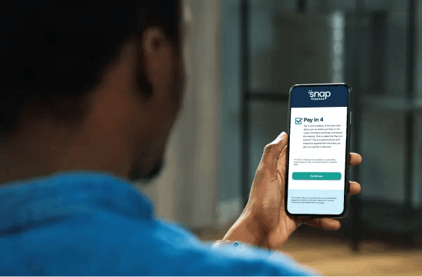 Man looking at phone with pay in 4 screen