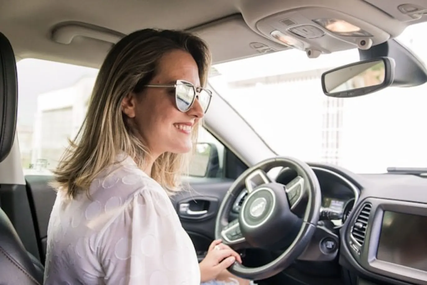 Woman in a car with sunglasses