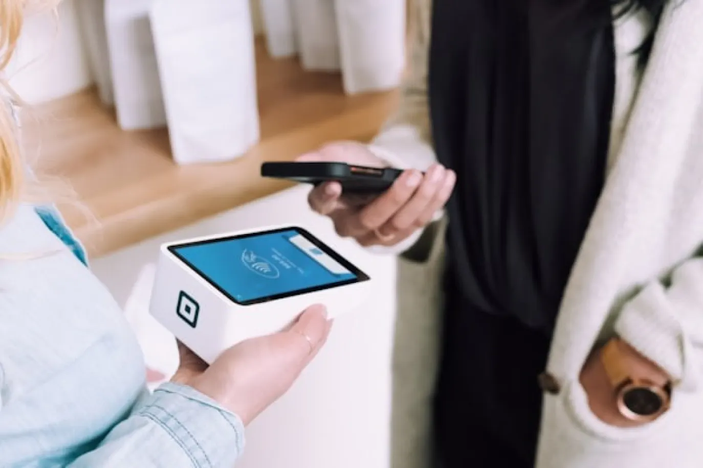 woman holding white POS machine