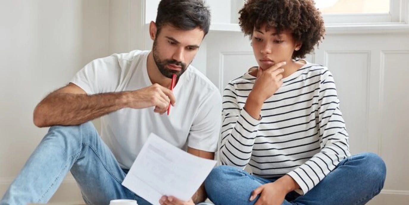 Man and woman looking at finance papers