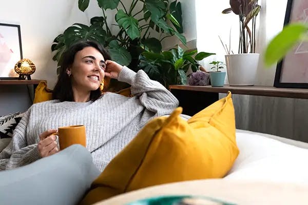 Woman sitting in the couch smiling