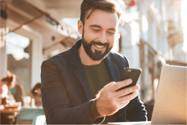 A man is looking at his phone in a restaurant 